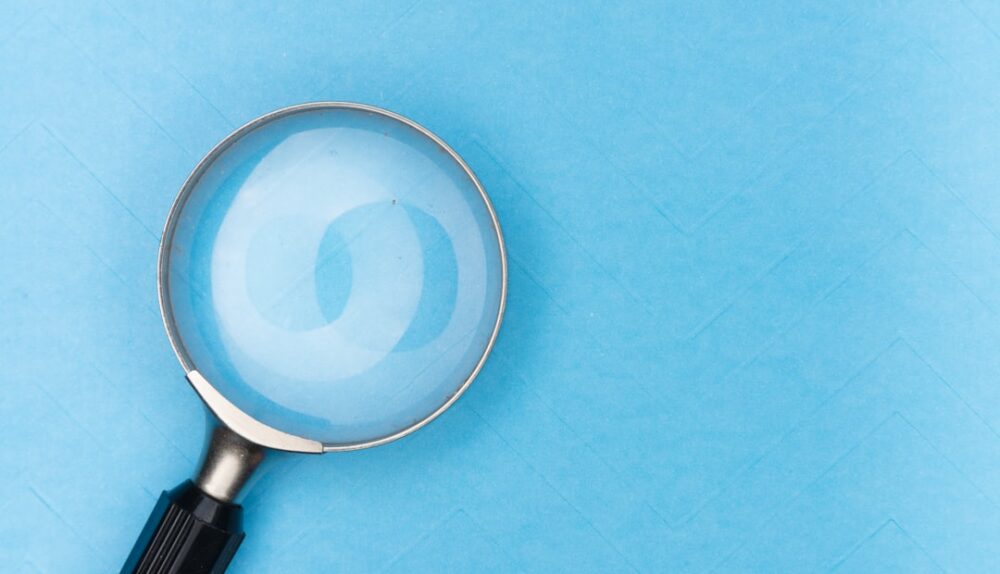 a magnifying glass on a blue background